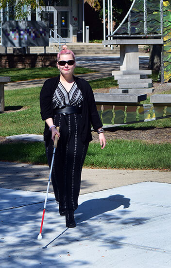 woman with cane outside