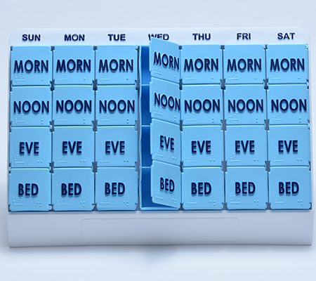 pill box containing spaces for each day along with morning, noon, eve, and bed spaces for pills