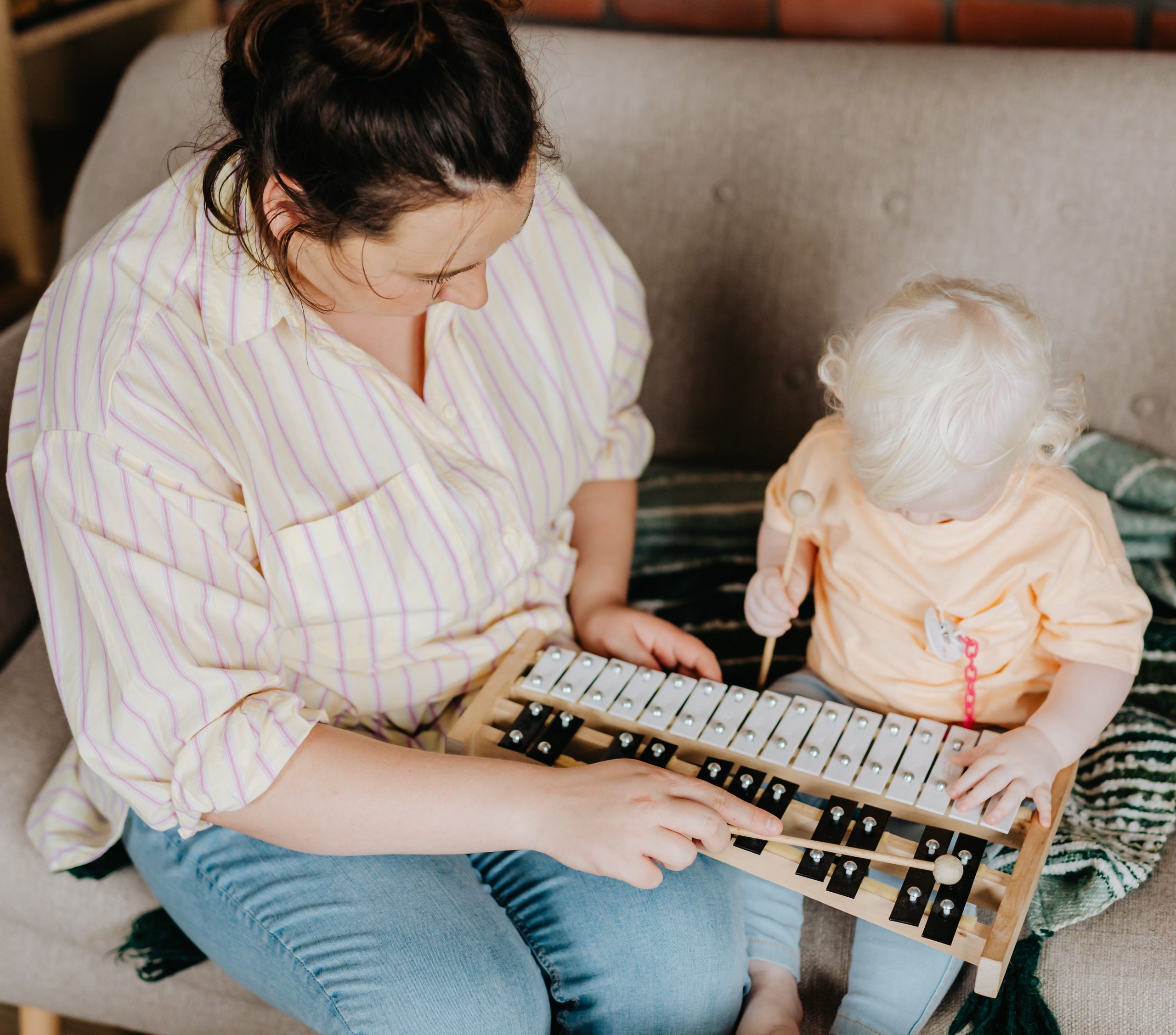 Young child with parent playing music set